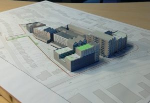 A 3D-printed architectural model of a mixed retail and housing development, made by Oxford Hackspace for a customer.